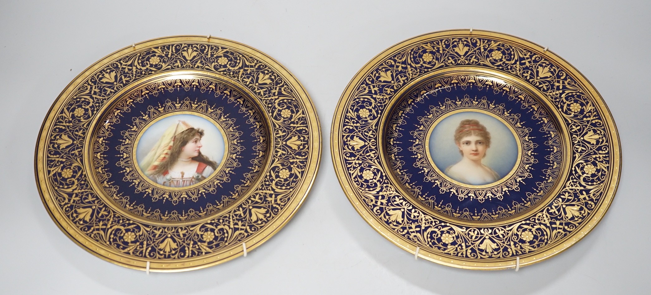 A pair of Pirkenhammer gilt and portrait painted cabinet plates, 25cm diameter